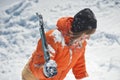 Girl climber climbs a snow cornice using ice axes through snow blown away by the strong wind. Royalty Free Stock Photo