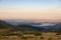 Girl climber contemplates a amazing sunset and moonrise. Royalty Free Stock Photo