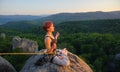 Girl climber on mountain peak on high altitude in evening Royalty Free Stock Photo