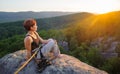 Girl climber on mountain peak on high altitude in evening Royalty Free Stock Photo