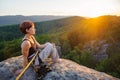 Girl climber on mountain peak on high altitude in evening Royalty Free Stock Photo