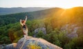 Girl climber on mountain peak on high altitude in evening Royalty Free Stock Photo