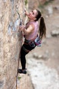 girl climber snaps a rope into a quickdraw. rock climber on a difficult route Royalty Free Stock Photo