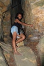 Girl climbing into cave