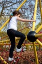 Girl climbing a frame in a playground Royalty Free Stock Photo