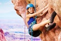 Girl climbing with harness high in the mountains Royalty Free Stock Photo