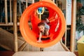 Girl climbing the maze in children game center