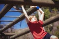 Girl climbing monkey bars during obstacle course training Royalty Free Stock Photo