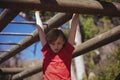 Girl climbing monkey bars during obstacle course training Royalty Free Stock Photo