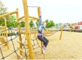 The girl climbing and sliding on slide in the playground. Happy children playing and having fun at playground Royalty Free Stock Photo