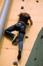 A girl climbing to the top of the wall