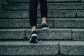 The girl climbs on concrete stairs