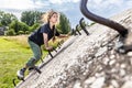 The girl climbs on the concrete wall