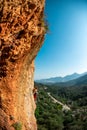 The girl climbs the rock. Climber trains on natural terrain. Extreme sport. Lessons on the street. A woman overcomes a difficult