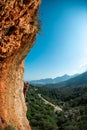 The girl climbs the rock. Climber trains on natural terrain. Extreme sport. Lessons on the street. A woman overcomes a difficult Royalty Free Stock Photo