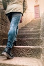 Girl climbs steps of a ladder, atop a bright door. concept of vocation, unknown, destiny Royalty Free Stock Photo