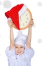 Girl with clock, Santa red hat and snow Royalty Free Stock Photo