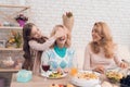 The girl closes eyes to her grandmother. She wants to make a surprise.