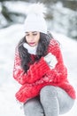 Girl closes her eyes shaking from cold outdoors on a freezing winter day