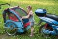 The girl closes the little boy in cart trailers to Royalty Free Stock Photo