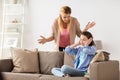 Girl closing ears to not hear angry mother at home Royalty Free Stock Photo