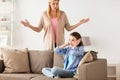 Girl closing ears to not hear angry mother at home Royalty Free Stock Photo