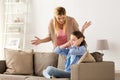 Girl closing ears to not hear angry mother at home Royalty Free Stock Photo