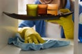 Girl with a cloth cleaning shelf