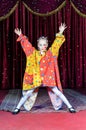 Girl Clown Standing with Open Arms on Stage Royalty Free Stock Photo