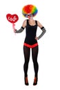 Girl in a clown suit holding a red heart Royalty Free Stock Photo