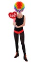 The girl in a clown suit holding a red heart Royalty Free Stock Photo