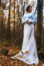 Girl in coat standing in autumn forest