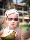 Girl with coconut on beach