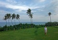 Girl, coconut palms on the shore of the Indian Ocean