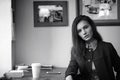 Girl with coffee. Young beautiful girl is sitting in a cafe and Royalty Free Stock Photo