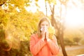 Girl with cold rhinitis on autumn background. Fall flu season. I Royalty Free Stock Photo