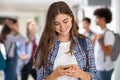 Girl in college school using smartphone Royalty Free Stock Photo