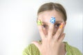 Girl with coloful adhesive plasters on her fingers