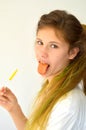 Girl with colored strands and with a lollipop