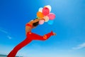 Girl with colorful balloons jumping