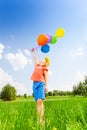 Girl with colorful balloons wears flower circlet