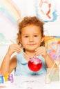 Girl coloring New Year ball for Christmas tree