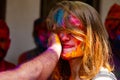 Girl with colors at Holi festival of colors in Delhi India on 2d