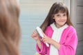 Girl combing long hair at home with a comb Royalty Free Stock Photo