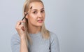 A girl combs her eyebrows with a brush after dyeing in a beauty salon.Professional makeup and cosmetology skin care