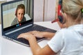 A girl communicates with a boy using a webcam on a laptop while sitting at home Royalty Free Stock Photo