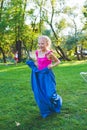 Girl compete in a relay race . Jumping in bags . They laugh and fall . Royalty Free Stock Photo