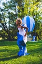 Girl compete in a relay race . Jumping in bags . They laugh and fall . Royalty Free Stock Photo