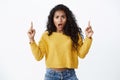 Girl complaining feeling betrayed and upset. Bothered african-american curly-haired woman in yellow sweater looking Royalty Free Stock Photo