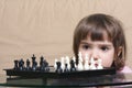 Girl considering chess position